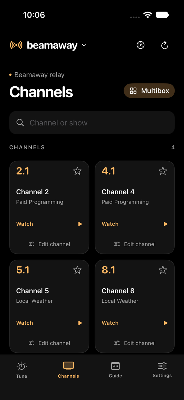 Beamaway on iPhone: channel cards with what's on now, a search field and the Multibox button.